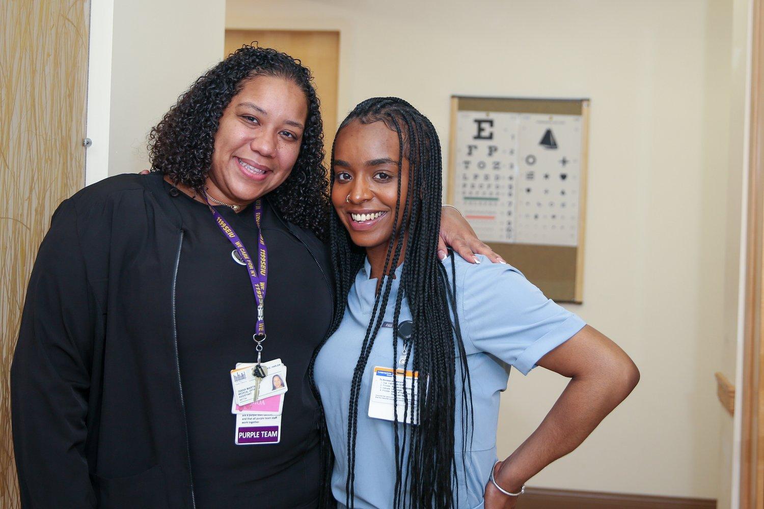 Two health center staff smiling